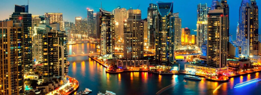 Stunning view of luxury high-rise apartments and picturesque canal in Dubai Marina, showcasing waterfront living at its finest.
